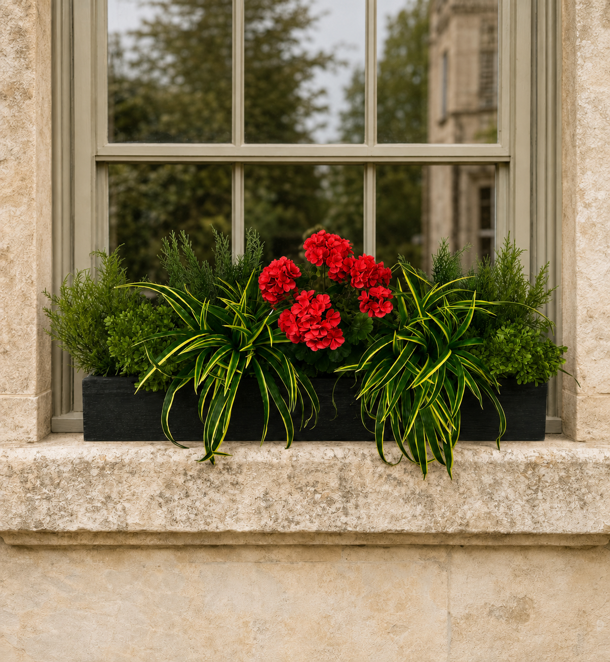 Artificial Red Geranium and Dracaena Grass Window Box Artificial red geranium and dracaena grass window box displayed on a stone window sill