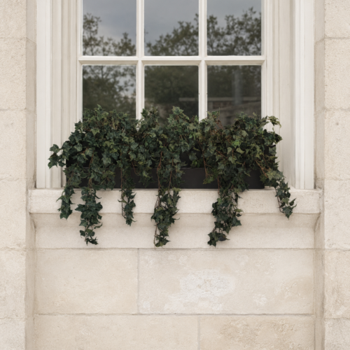 Artificial Woodland Ivy Window Box displayed on a stone window ledge