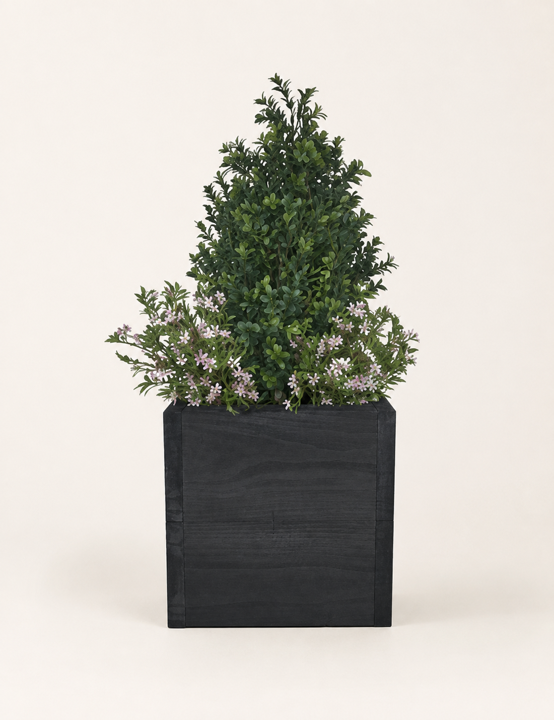 Artificial Buxus Shrub in Timber Planter with Pink Flowers Artificial buxus shrub with delicate pink flowers in a black rustic timber planter