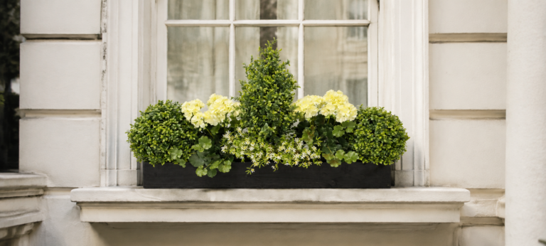 artificial trough and artificial windowbox with greenry and flowers